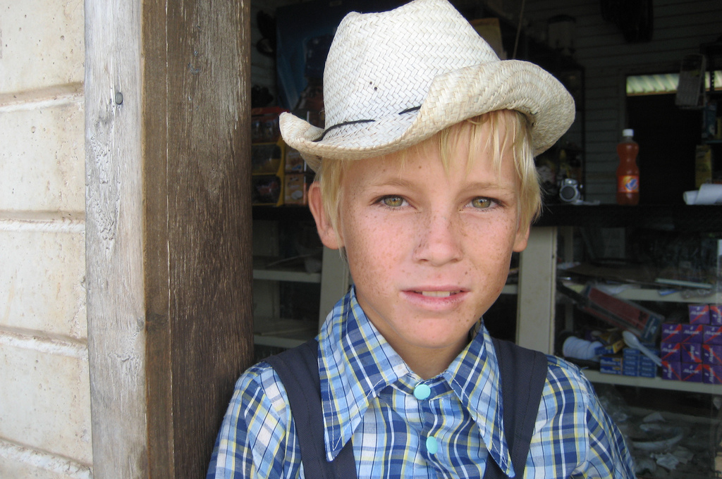 Mennonite boy in typical clothes (hat & overall)