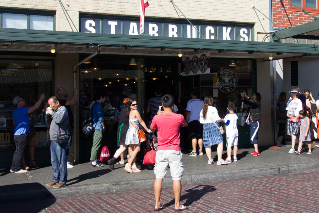 People shooting away in front of the first Starbucks